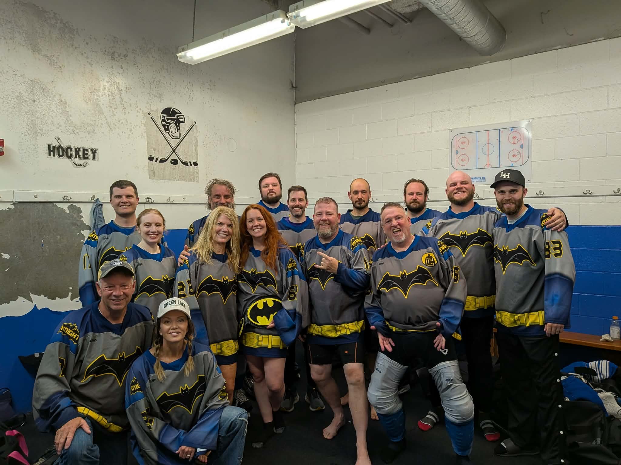 The Dark Knights pose together in the locker room in their bat-themed jerseys
